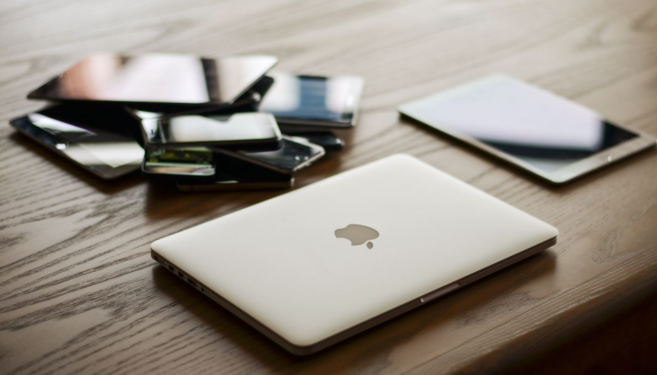 Laptop, tablet and phones on a work table