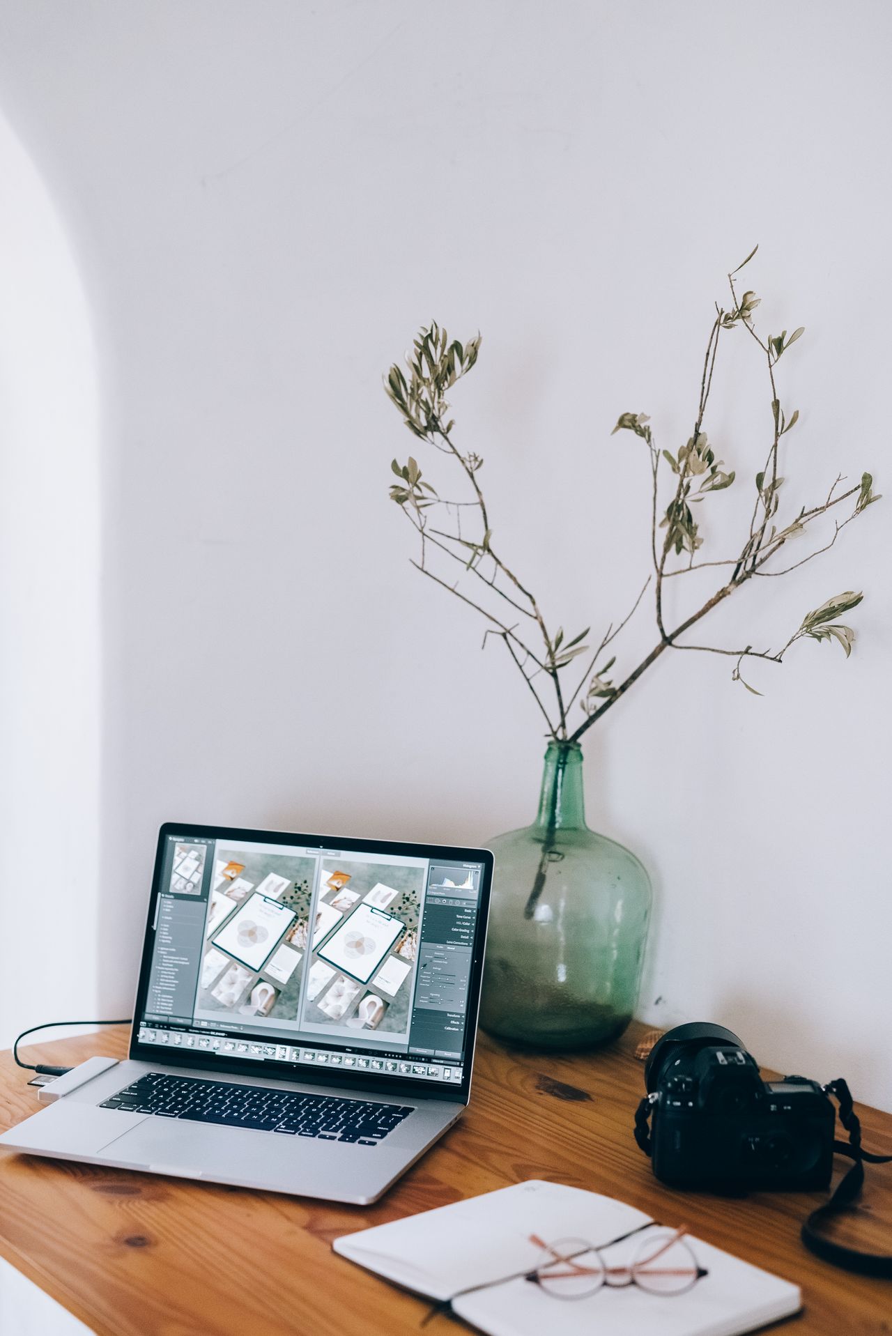 Camera and laptop at a photography workspace