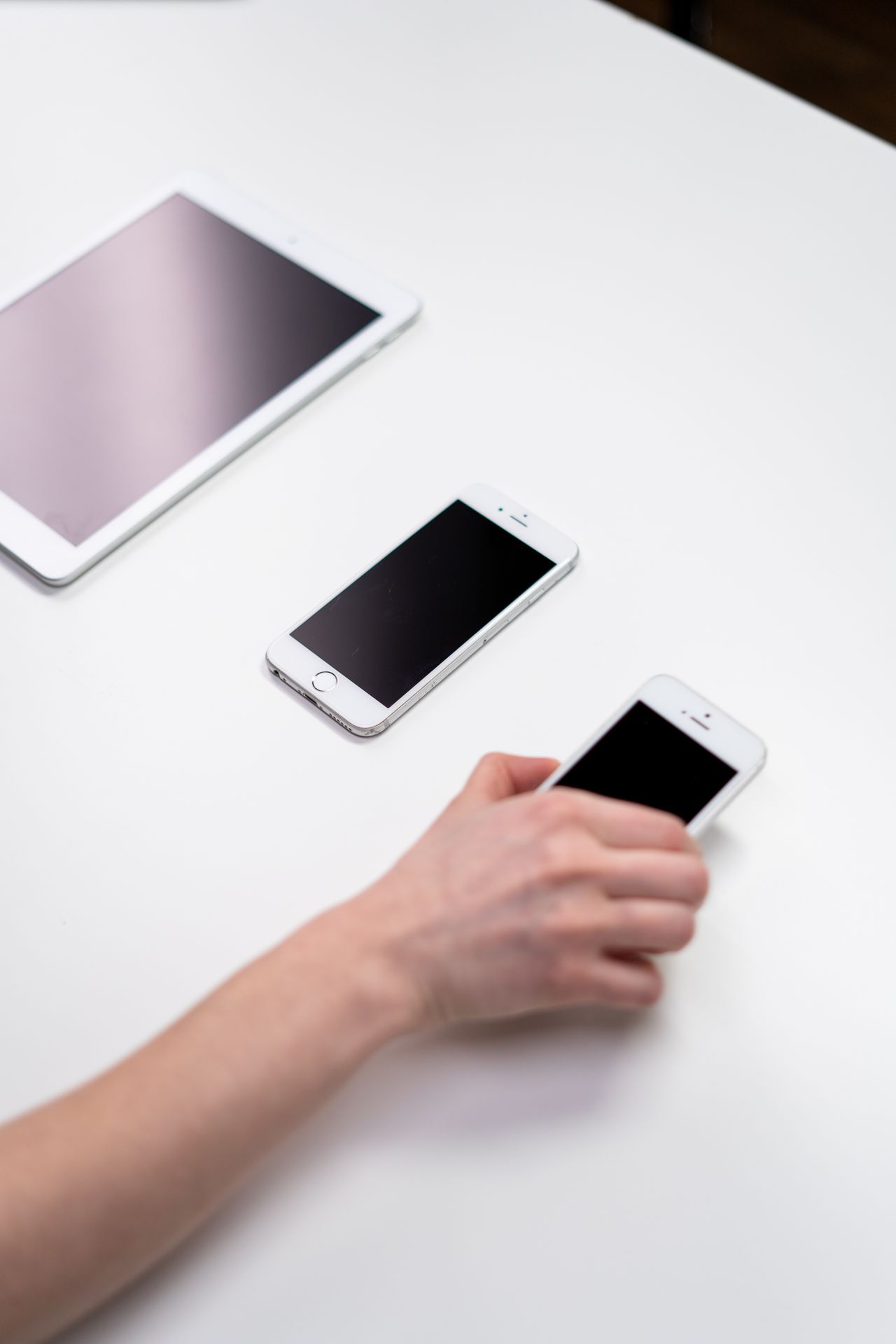 Tablet and smartphones on a white table