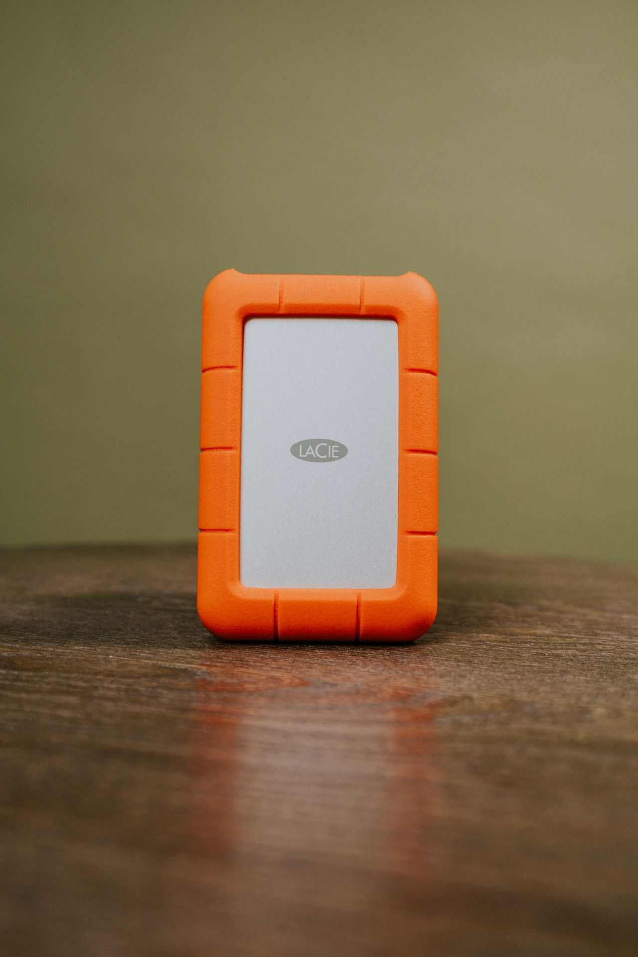 External drive in an orange protective case