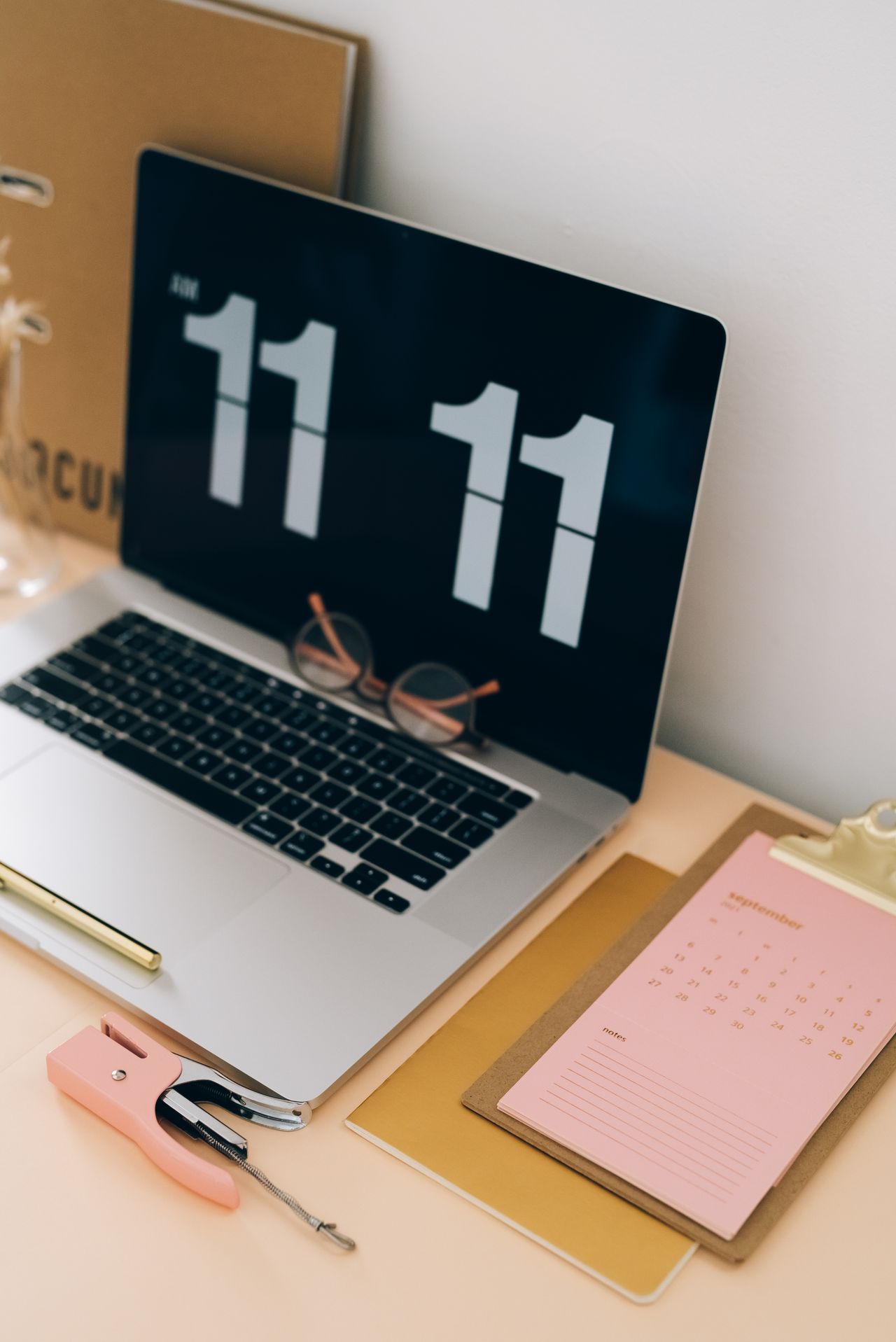 Calendar beside a laptop displaying the time