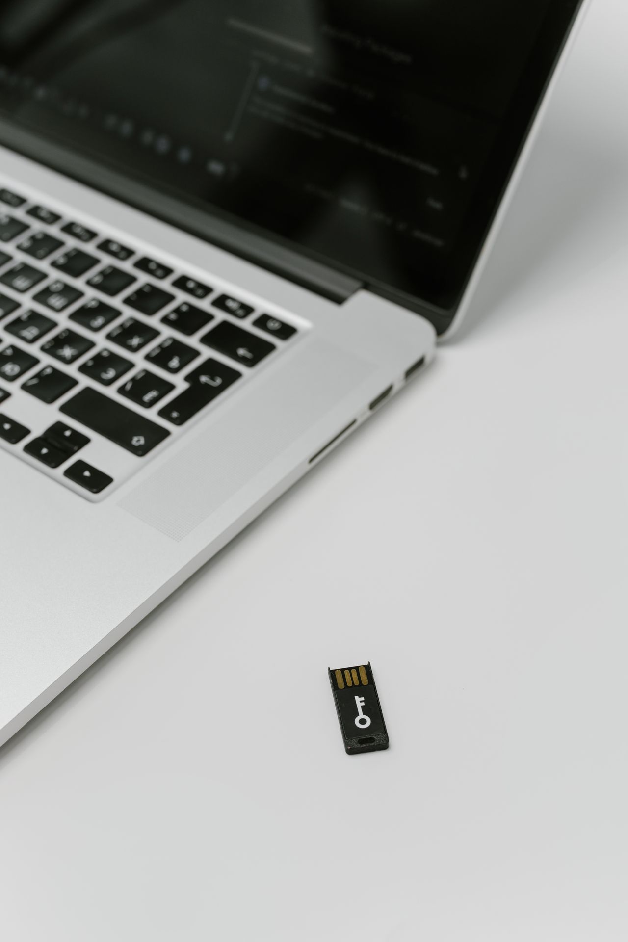 USB security key beside a laptop