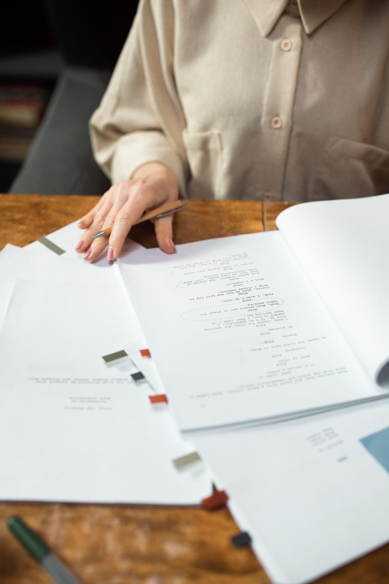 Hands organizing several printed pages