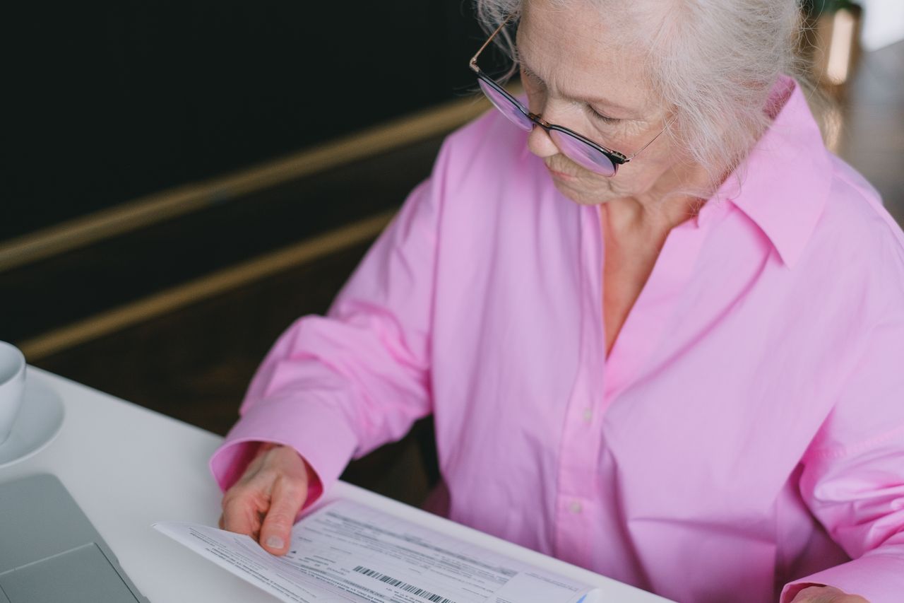 A person reading a multipage document