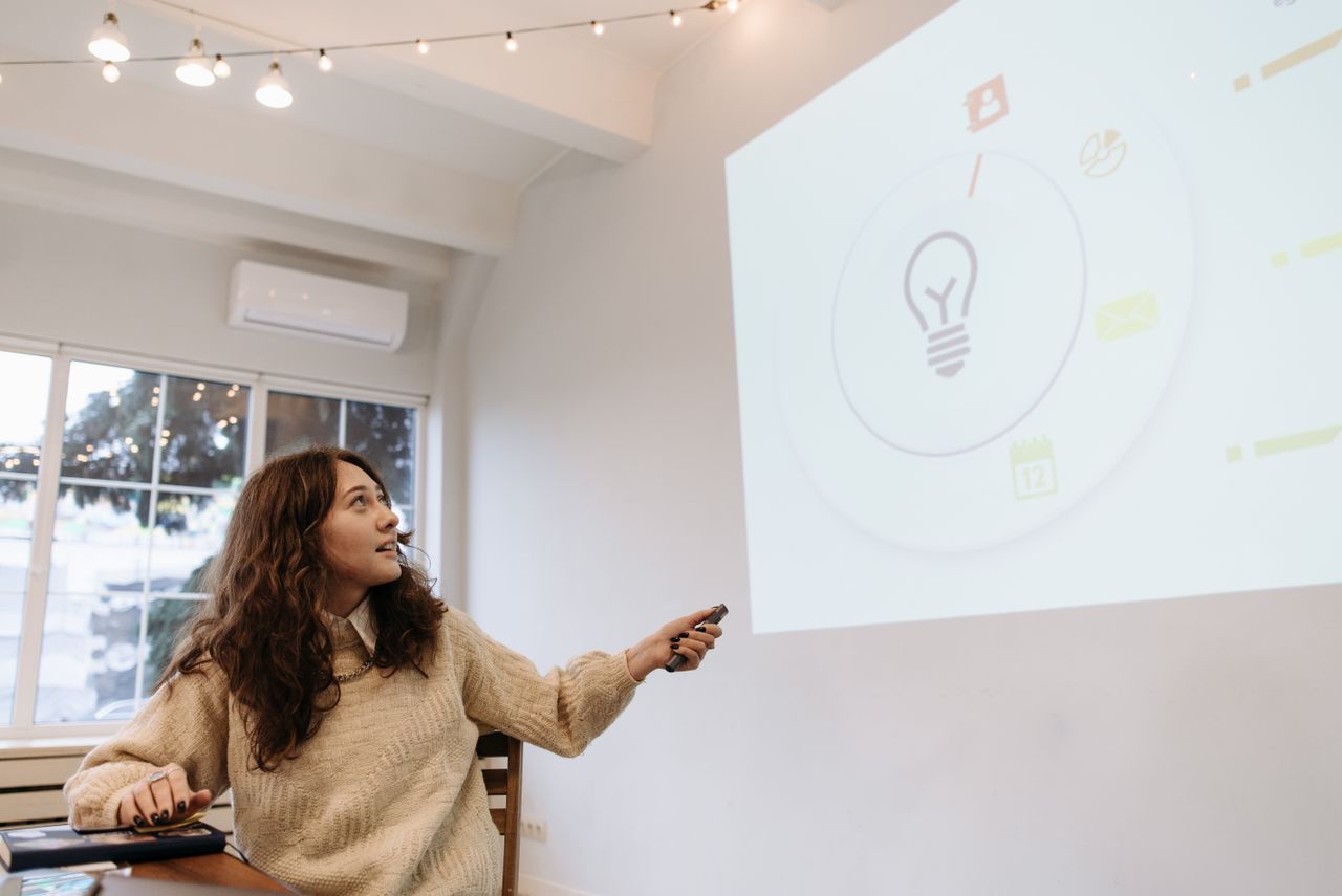 A person explaining an onscreen presentation