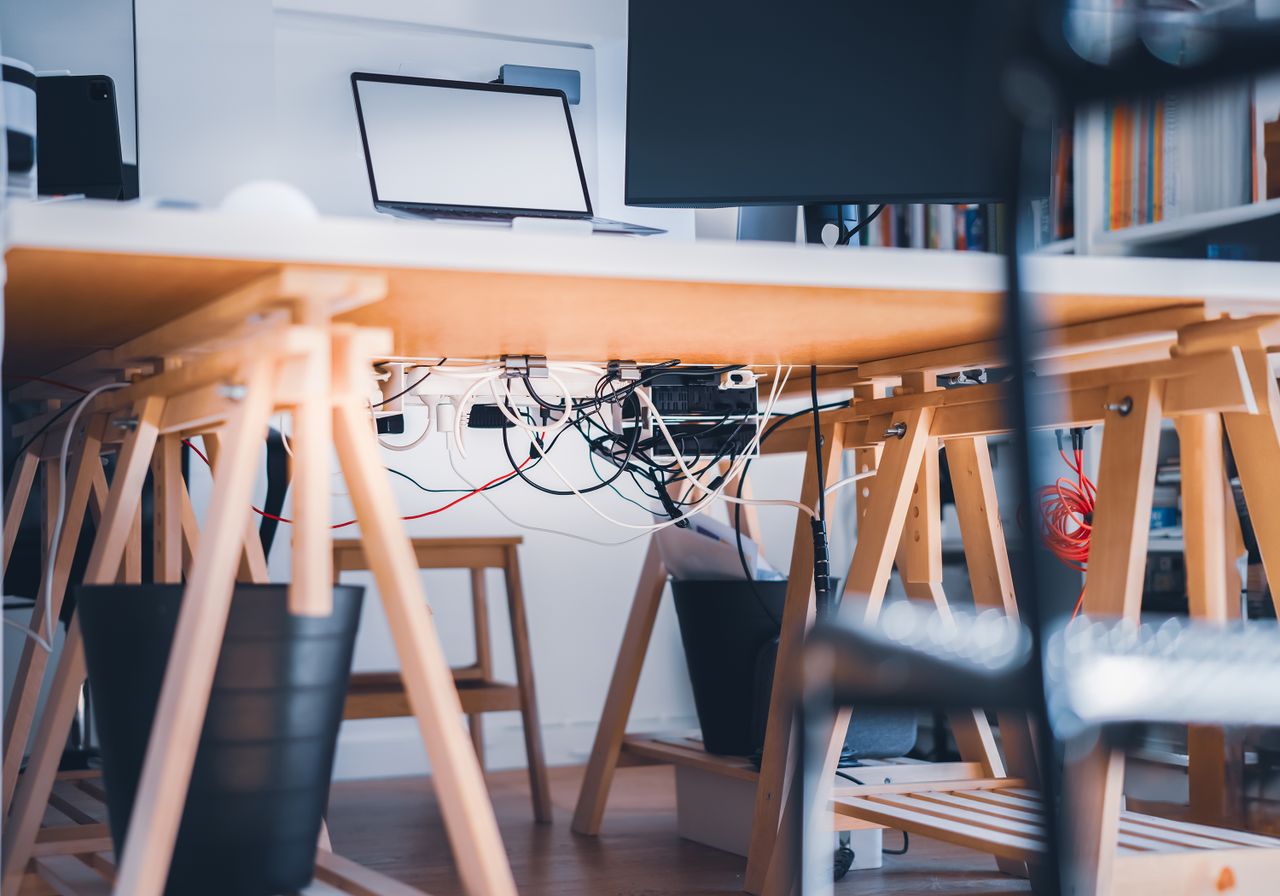 Visible cables beneath a computer desk