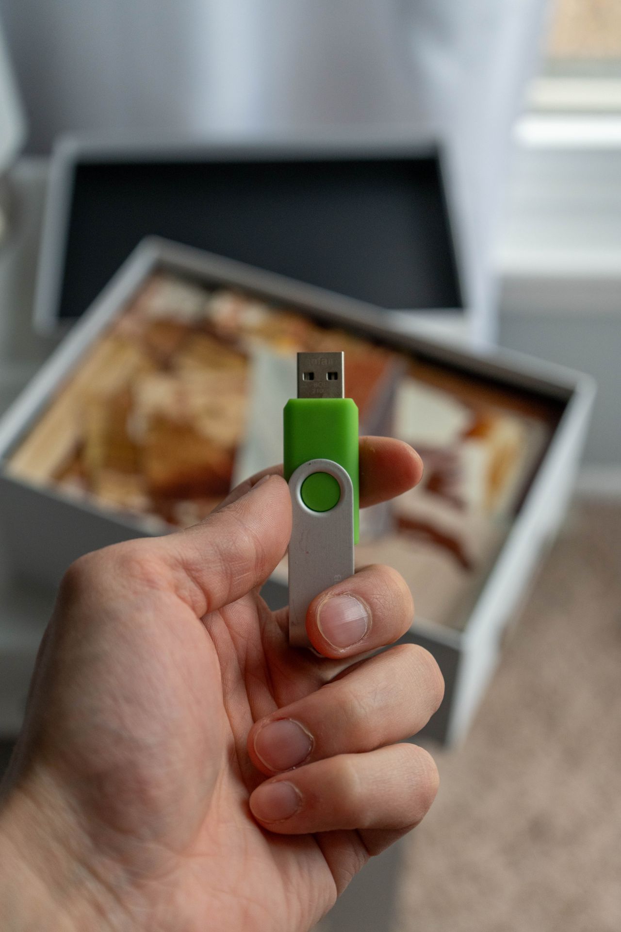 A hand holding a USB storage drive