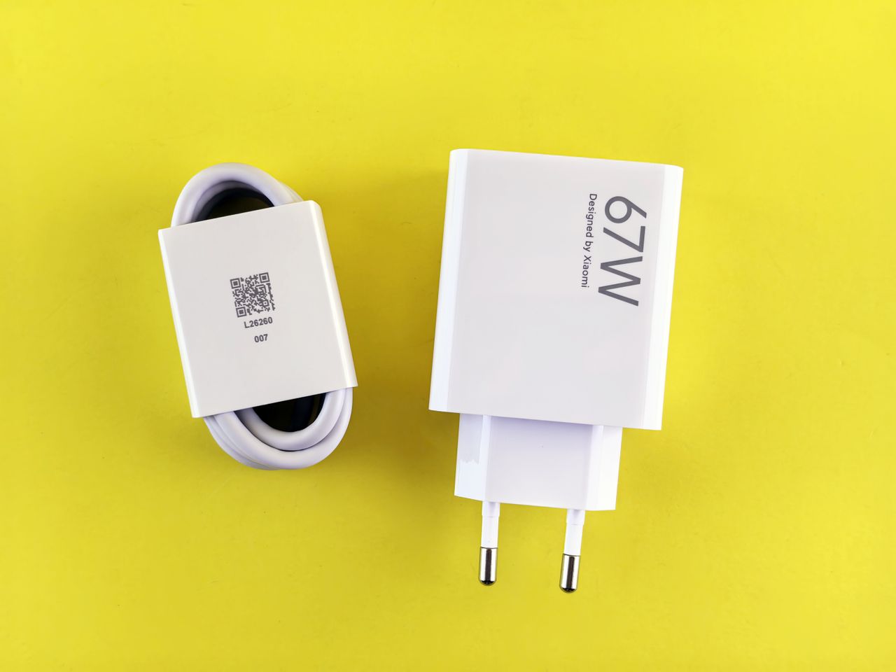 Charger showing a power rating with a USB cable