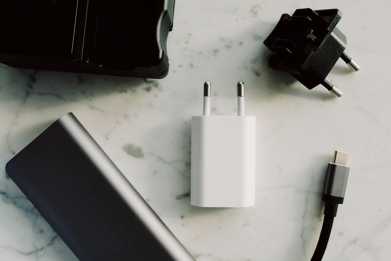 Various adapters and chargers on a light surface
