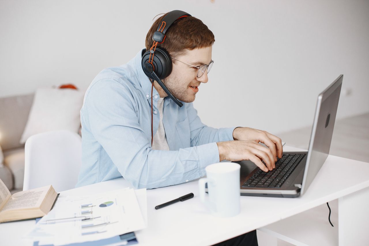 Working on a laptop with headphones