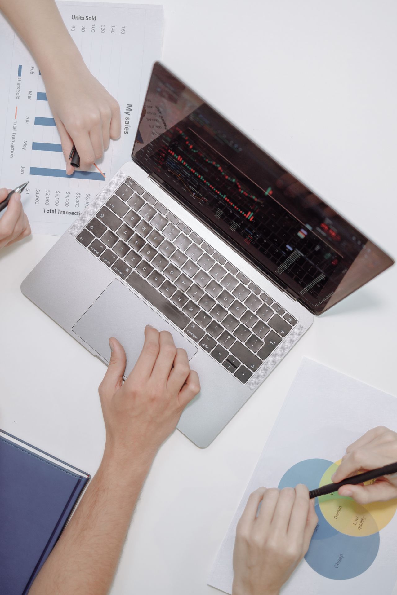 Working together on documents and a laptop