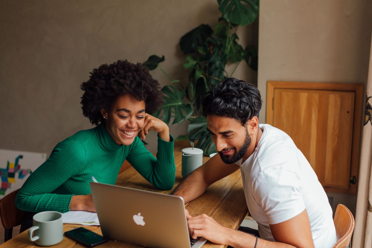 Two people looking at a laptop together