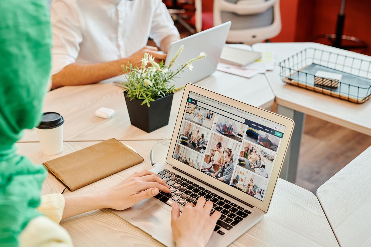 Typing on a laptop in a shared office