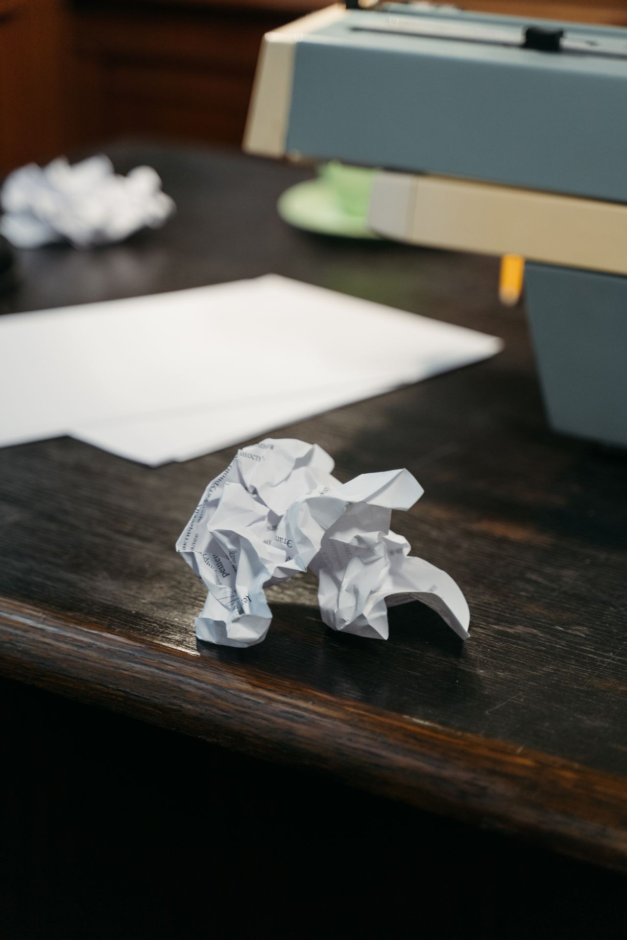 Paper on a desk beside a printer