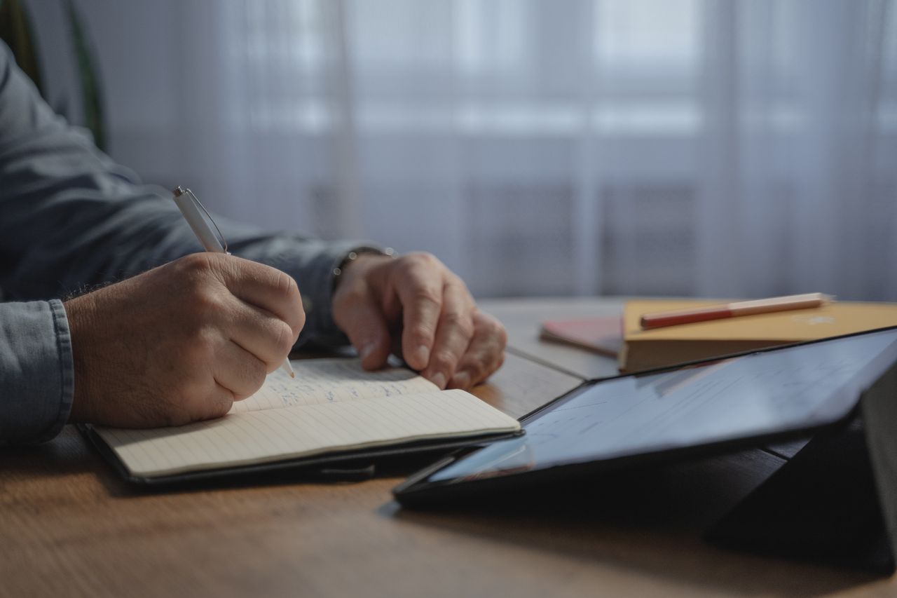 Handwritten notes beside a tablet