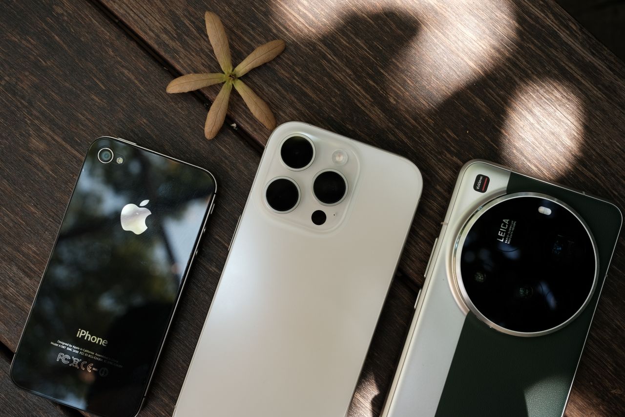 Three smartphones on a wooden surface